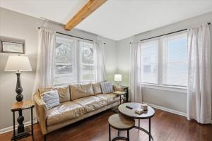 a living room with a couch and a table at Waldo Craftsman - Fenced yard Walkable to dining in Kansas City