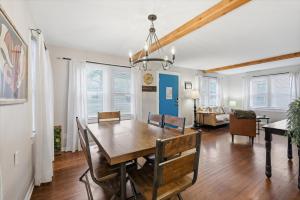 a dining room and living room with a table and chairs at Waldo Craftsman - Fenced yard Walkable to dining in Kansas City