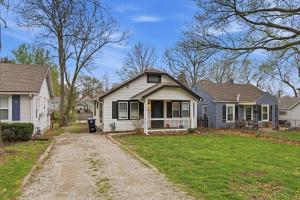 a house with a dirt road in front of it at Waldo Craftsman - Fenced yard Walkable to dining in Kansas City