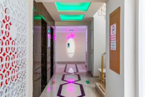 a hallway with pink and purple floors and a window at The Suites in Antalya