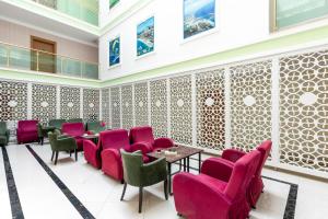 a restaurant with pink chairs and tables in a room at The Suites in Antalya +58 photos