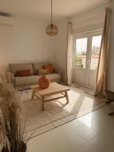 a living room with a couch and a coffee table at Dodos Guardias Viejas - Almerimar in El Ejido