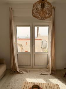 a room with a large window with a view of a building at Dodos Guardias Viejas - Almerimar in El Ejido