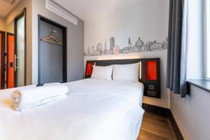 a bedroom with a white bed and a window at easyHotel Cardiff in Cardiff +31 photos