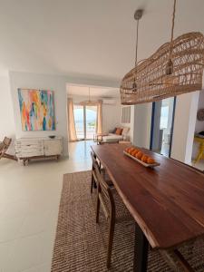 a dining room with a table and a living room at Dodos Guardias Viejas - Almerimar in El Ejido +27 photos