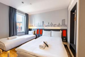 a room with two beds and a window at easyHotel Cardiff in Cardiff