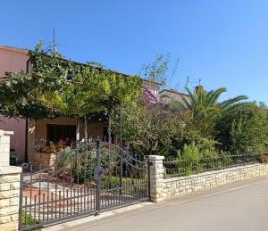 a wrought iron fence in front of a house at Apartment Vesna in Medulin