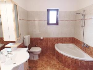 a bathroom with a tub and a toilet and a sink at Apartment Vesna in Medulin +12 photos