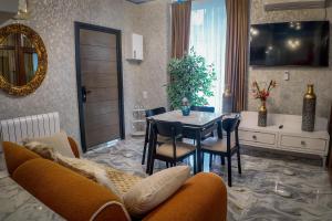 a living room with a table and a dining room at Green Corner Kutaisi in Kutaisi