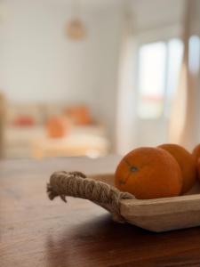 a bowl of oranges on a wooden table at Dodos Guardias Viejas - Almerimar in El Ejido