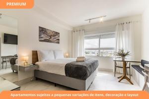 a bedroom with a bed and a desk at Connect João Wallig by My Way in Porto Alegre +48 photos