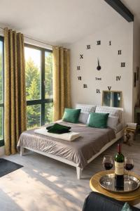 a bedroom with a bed and a window with wine glasses at Romantik 2-6P in Mürlenbach