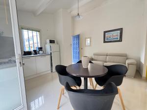 a kitchen with a table and chairs in a room at maison Eglantine in Gréoux-les-Bains