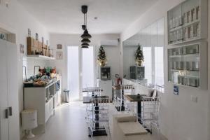 a kitchen with tables and chairs in a room at Il Vicoletto B&B - In pieno centro in Cirò Marina