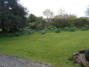 a grassy yard with a gazebo in a garden at Acorns in Wavehorne