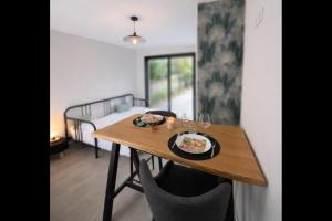 a dining room table with a plate of food on it at Studio du port avec jardin privé in Saint-André-de-Cubzac