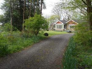 a gravel road in front of a house at Acorns in Wavehorne