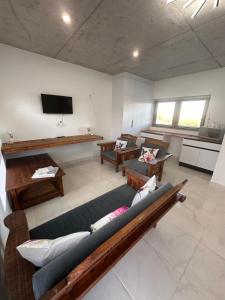 a large living room with couches and a flat screen tv at Our Little Cottage in George