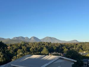 a view of mountains from the roof of a house at Our Little Cottage in George