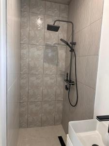 a shower with a glass door in a bathroom at Our Little Cottage in George +10 photos