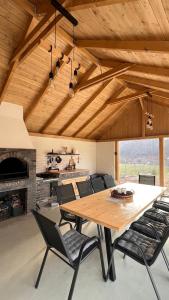 a dining room with a large wooden table and chairs at Le Cabane Retreat in Lereşti
