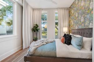 a bedroom with a bed with a large window at Luxe 19BR Combo & Private Backyard with Pool in New Orleans