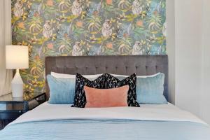 a bedroom with a bed with a floral wallpaper at Luxe 19BR Combo & Private Backyard with Pool in New Orleans