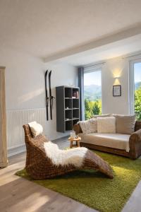 a living room with a couch and a chair at Romantik 2-6P in Mürlenbach +25 photos