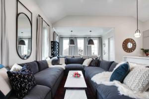 a living room with a gray couch and a table at 14BR Downtown Combo & Shared Seasonal Pool in New Orleans