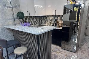 a kitchen with a black and white counter top at Green Corner Kutaisi in Kutaisi +62 photos