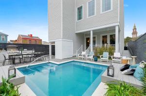 a swimming pool in front of a house at 14BR Downtown Combo & Shared Seasonal Pool in New Orleans