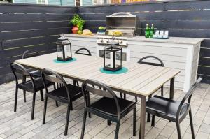 a table and chairs on a patio with a kitchen at 7BR City Condo & Pool Access Near CBD in New Orleans