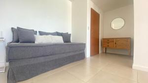 a bedroom with a bed with a dresser and a mirror at Bella Vista in Puerto Madryn