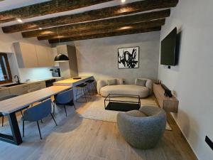 a kitchen and living room with a table and chairs at Stone house Anic in Vela Luka