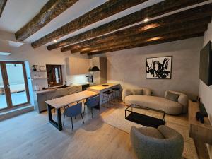 a living room with a table and chairs and a kitchen at Stone house Anic in Vela Luka