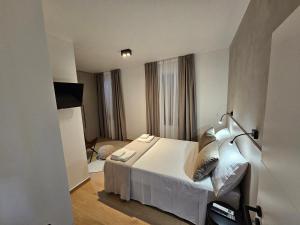 a bedroom with a white bed in a room at Stone house Anic in Vela Luka