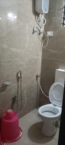 a bathroom with a toilet and a shower at Chavan guest house in Akalkot
