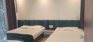 two beds in a small room at Chavan guest house in Akalkot