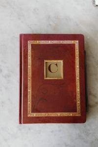 a red book with a gold frame on a table at Cosmopolitan Hotel in San Diego