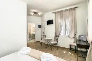 a room with a bed and a table and chairs at Livanios Studios in Adamantas