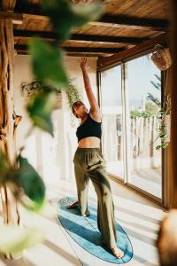 a woman standing on a surfboard in a room at Surf HouseMaroc in Essaouira