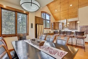 a dining room with a table and a kitchen at Slopeside Villa 126 Next To WP Resort I Steam Shower I Great Views I Private Hot Tub I Activity Program in Winter Park