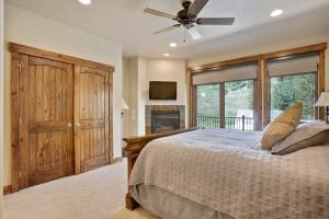 a bedroom with a bed and a ceiling fan at Slopeside Villa 126 Next To WP Resort I Steam Shower I Great Views I Private Hot Tub I Activity Program in Winter Park