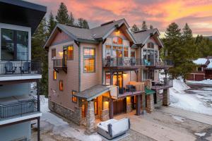 a house in the snow with a tv at Slopeside Villa 126 Next To WP Resort I Steam Shower I Great Views I Private Hot Tub I Activity Program in Winter Park