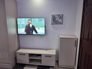 a tv on a wall with a man on it at Studio at El Karma Beach & Aqua Park in Hurghada