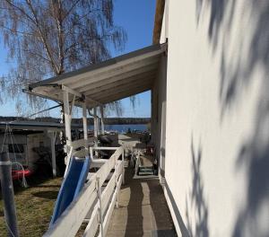 a porch of a house with awning and a slide at Rodzinna Przystań Arkadia in Dominice