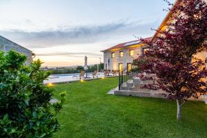 a house with a yard with a pool at Outeyro Retreat Country House in Marco de Canaveses
