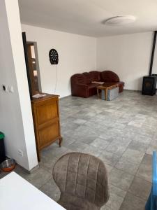 a living room with a couch and a table at Rodzinna Przystań Arkadia in Dominice