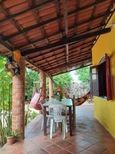 a patio with a table and chairs under awning at Quarto Privativo e Camping em Canoa Quebrada in Canoa Quebrada