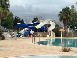 a blue water slide next to a swimming pool at rouge gorge in Valras-Plage
